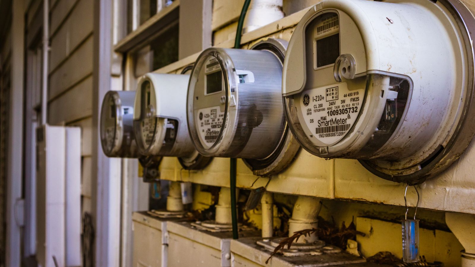 Genuine archival stock photograph of smart electricity meters installed on a wall. Illustrative only; not a Yuno Energy property or a photograph of the October 2026 announcement.