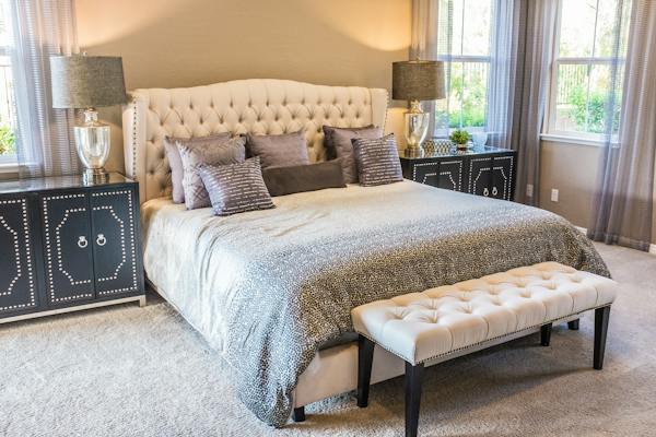A bed with pillows and bedding.